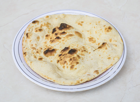 Tandoori Roti served in plate isolated on grey background side view of pakistani and indian spices food
