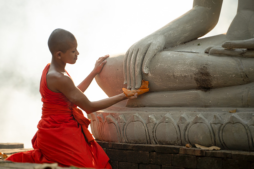 Young Buddhist monks admiring view of ancient temples in Bagan, Myanmar (Burma)