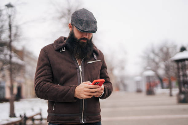 istock Bearded man using smart phone in the city 1934224683