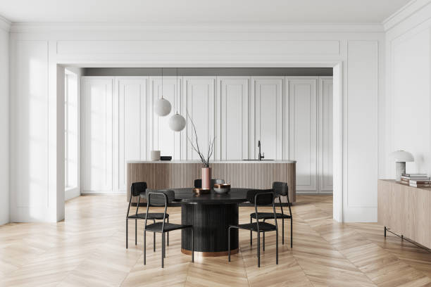 istock Stylish home kitchen interior with eating table and counter, sideboard 1934225756