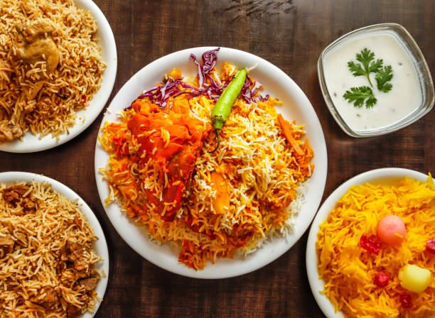istock Assorted biryani, pulao with beef, chicken and zarda color ful rice served in plate isolated wooden background top view indian sweet and pakistani dessert food 1934228471