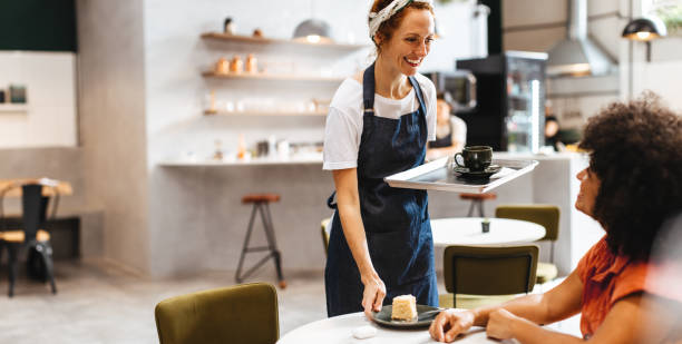 istock Restaurant waitress serving a customer her food 1934237052