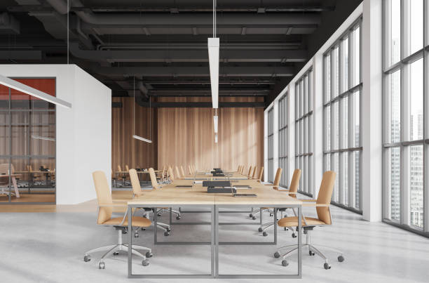 istock Modern office loft interior with shared desk and laptop, panoramic window 1934240234