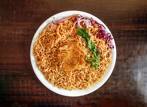 Plain pulao with shami kabab onion and cabbage served in plate isolated wooden background top view indian spices and pakistani food