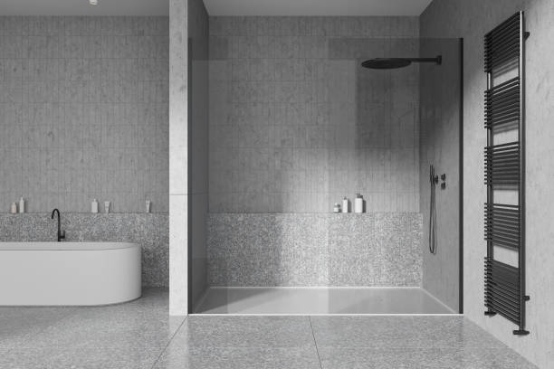 istock Grey home bathroom interior with shower and tub with rail, accessories 1934252035