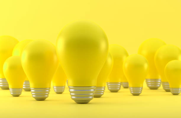 Yellow Light Bulb And Standing Out From The Crowd On Yellow Background