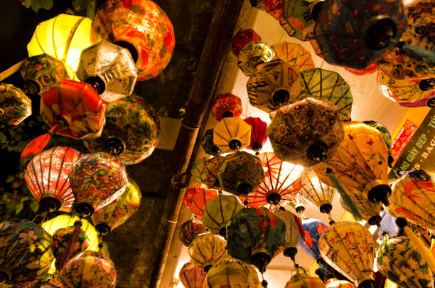 This photograph was taken on November 15, 2023 in Hoian (Vietnam). Hoian is a beautiful city in the center of the country, where you can walk along the river and photograph the traditional boats decorated with painted eyes and colorful lanterns throughout the city that begin to shine as soon as it gets dark.It is crossed by canals. The cosmopolitan history of the former port city is reflected in its architecture, a fusion of eras and styles, from temples and wooden Chinese shops to colorful French colonial buildings, to highly ornate Vietnamese tube houses and the striking Japanese covered bridge, with its pagoda, now under reconstruction.