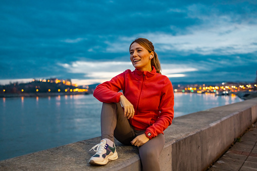 Attractive young woman taking a rest from her morning run