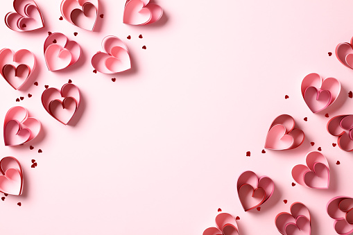 Frame of Valentines Day hearts and confetti on pink background. St Valentine's Day banner design, greeting card template.