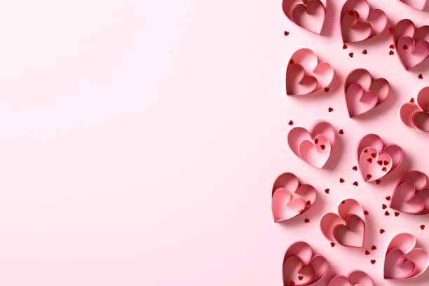 istock Saint Valentines Day flat lay composition with paper cut hearts and confetti on pink background. Top view, copy space. 1934294348