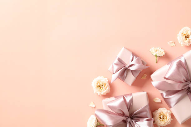 istock Valentines Day background with gift boxes and flowers on beige desk table. Top view. Flat lay. 1934308313