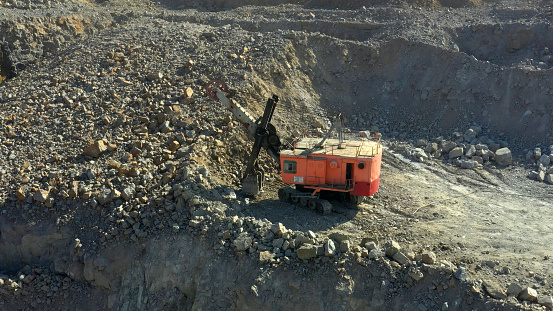 Quarryman Watching Earth Mover at Work in Marble Quarry.