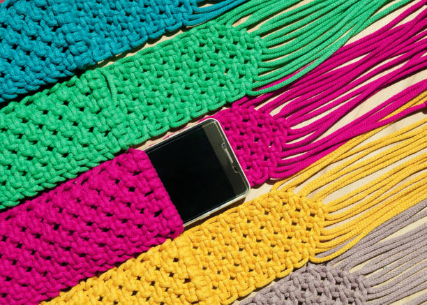 istock Multi-colored bags for mobile phones on a wooden background. 1934325773