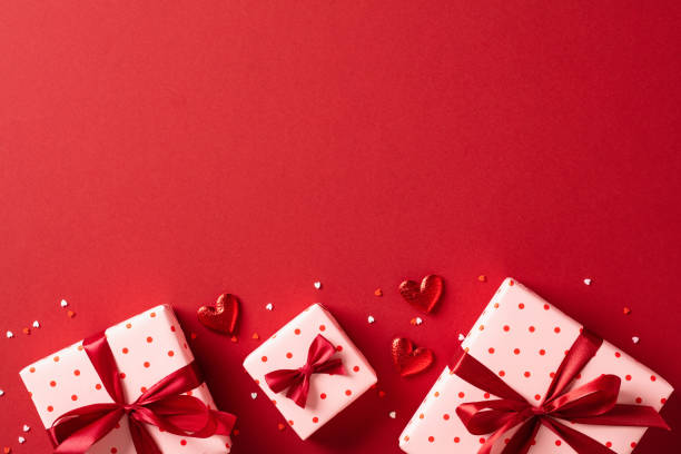 istock Valentines Day gifts with red hearts on red table. Top view, flat lay. 1934325783