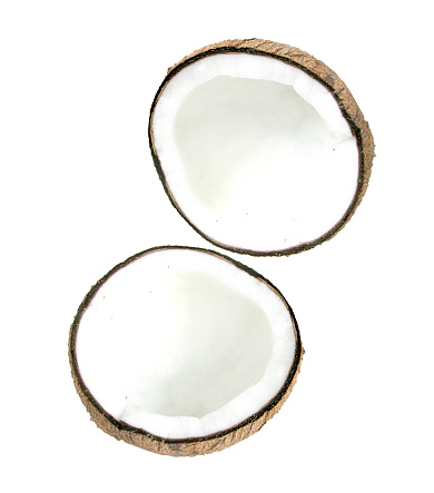 Halfs of coconut closeup on a white background