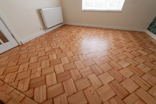 Lacquered pine parquet floor in an empty room