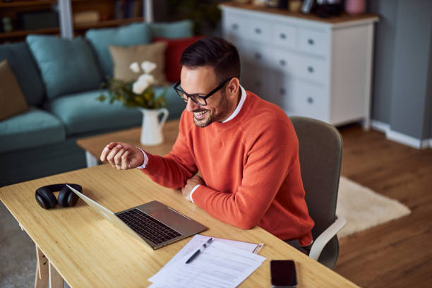 istock A top view of a male freelancer on a video call with a client on his laptop while sitting at a desk. 1934335037