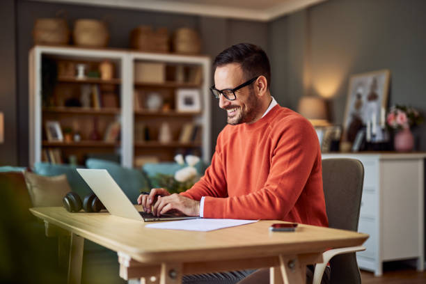 istock A smiling male freelancer typing on a laptop while working from a home office. 1934335079