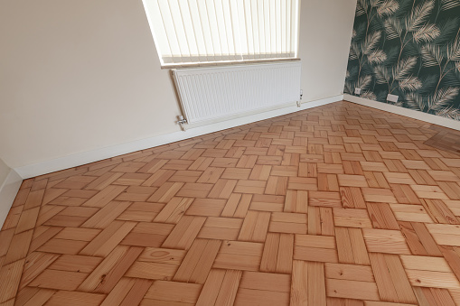 Lacquered pine parquet floor in an empty room