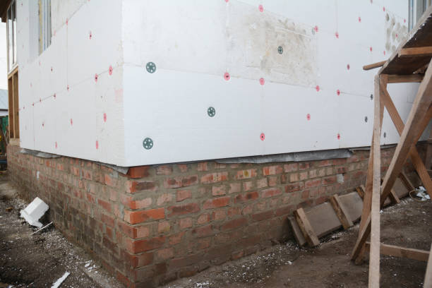 istock External wall rigid foam board insulation. A close up of a house corner with EPS foam insulation panels installed using anchors with large washers. 1934343787