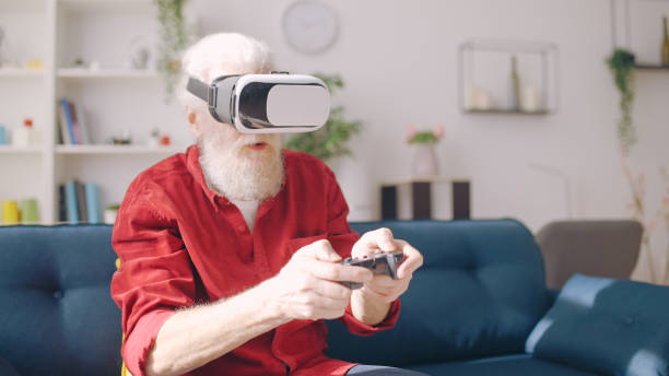 istock A contemporary senior man explores virtual reality using a VR headset, immersing himself in the game 1934345378