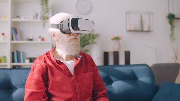 istock An elderly man wears virtual reality goggles in a modern interior, enjoying his leisure time 1934345386