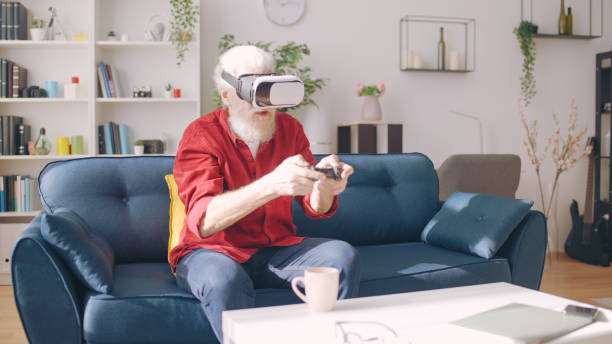 istock A man in his 60s engages in a video game using VR glasses, experiencing virtual reality entertainment 1934345918