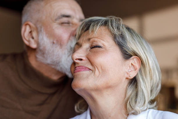 Enjoying a romantic kiss from her loving husband while having bonding moments