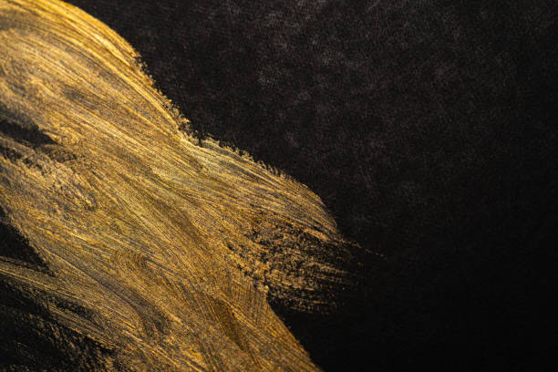 istock golden ink on black background 1934380722