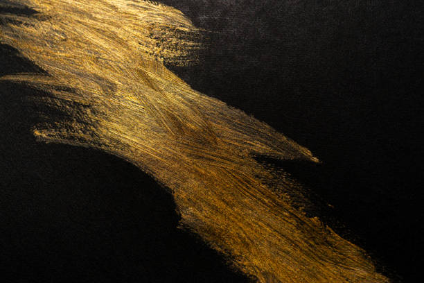 istock golden ink on black background 1934381241