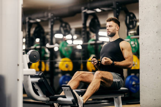 istock A strong muscular sportsman is working out on a pull weight machine in a gym. 1934381255