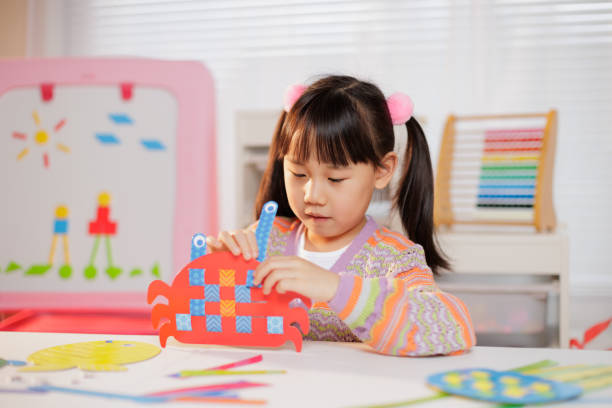 istock young girl making craft at home 1934387933