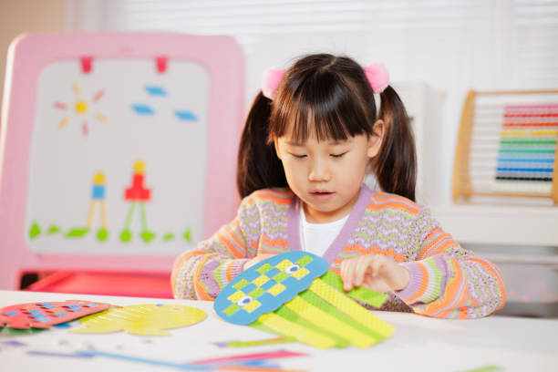 istock young girl making craft at home 1934388115