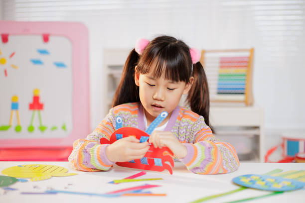 istock young girl making craft at home 1934388118