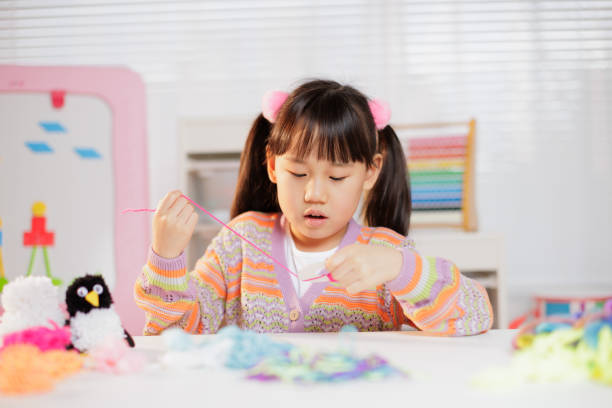 istock young girl making craft at home 1934388129