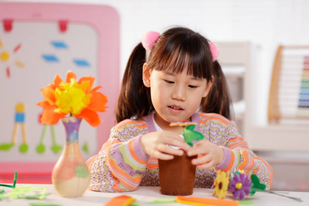 istock young girl making craft at home 1934388640