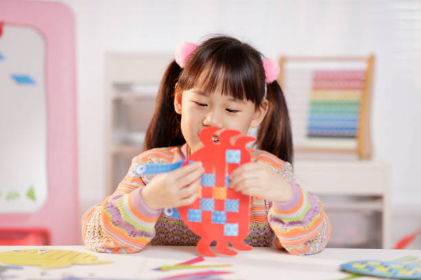 istock young girl making craft at home 1934389180