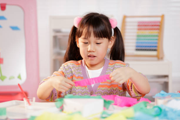 istock young girl making craft at home 1934389723