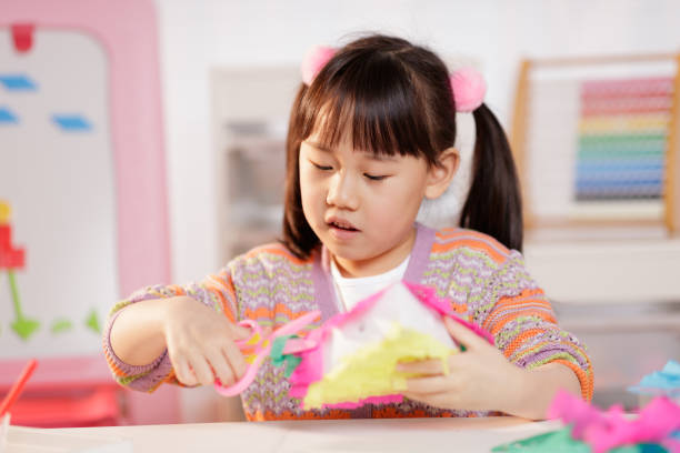 istock young girl making craft at home 1934389726