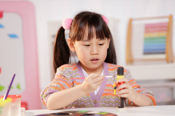 istock young girl making craft at home 1934389734