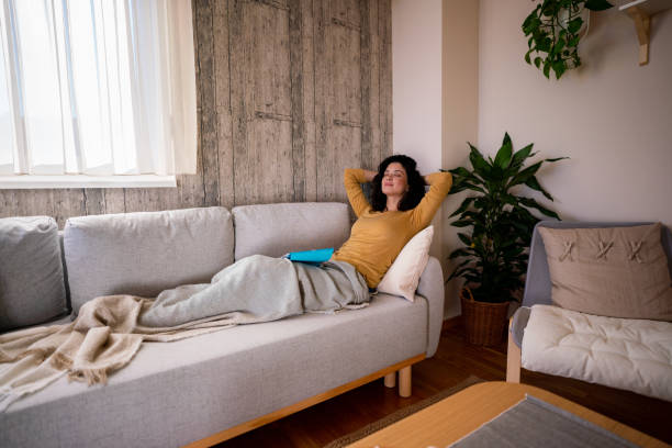 istock A woman rests on the sofa after reading a book 1934394993
