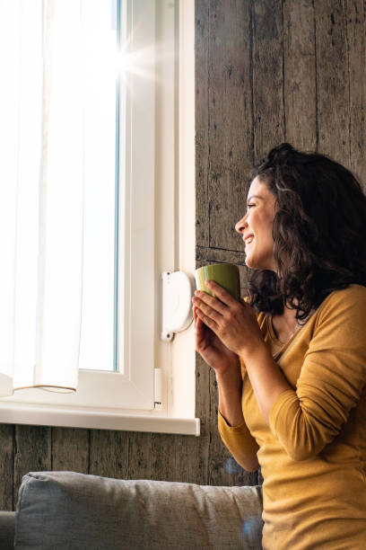 istock A woman drinks tea and looks out the window 1934397158