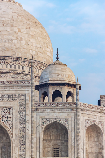 Main and smaller marble domes and decorative spires of Taj Mahal mausoleum. Close up photo. Agra, Uttar Pradesh, India