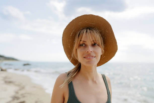 istock Smiling woman at the seashore 1934429927