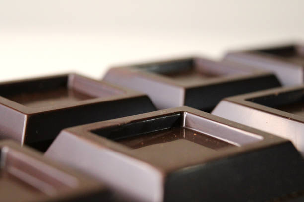 istock Extra dark bitter chocolate bar used in confectionery on a light beige background. Close up view. 1934456852