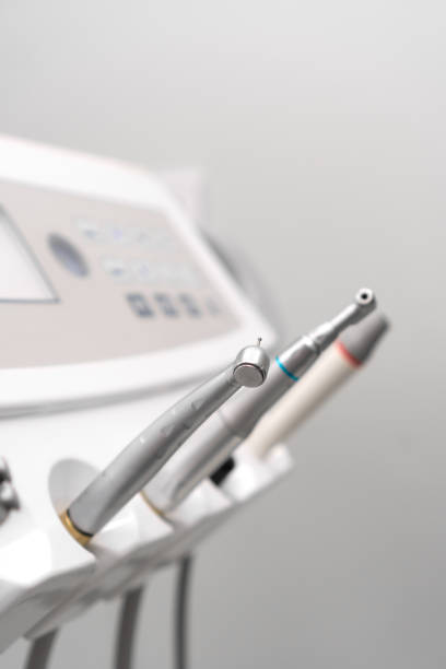 istock Close-up of dental instruments on a dental unit, selective focus. Various tips, ultrasonic scaler, surgical, endo- and periodontal tips. Vertical photo 1934463725