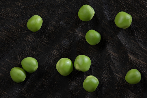 Green peas on a wooden background. Flat lay