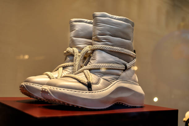 Beige warm comfortable high sole lace-up boots for winter weather on storefront.