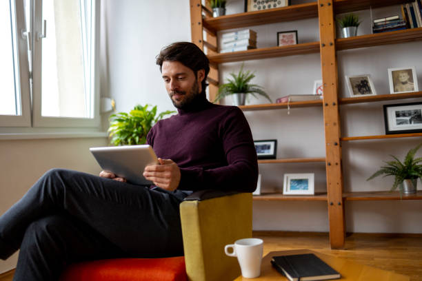 istock Low angle photo of man using digital tablet 1934508468