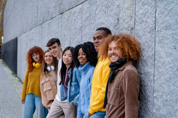 istock Group of friends lined up against a grey wall. 1934509547
